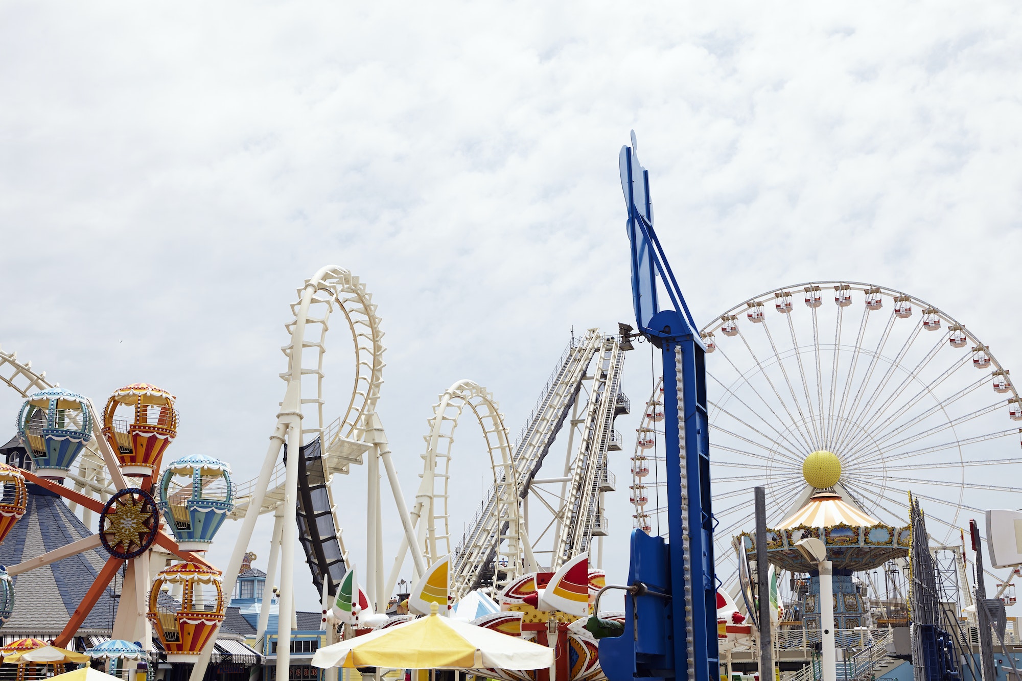 View of amusement park with rollercoaster and ferris wheel
