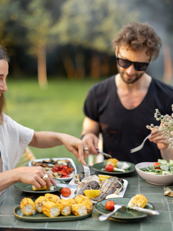 Couple having lunch with healthy food outdoors