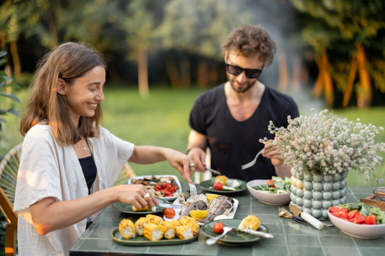 Couple having lunch with healthy food outdoors