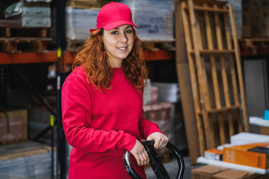 Female industrial worker using a scooter at a warehouse